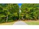 Paved walking trail winding through a lush wooded area, perfect for exercise and enjoying nature at 13912 Homer, Covington, GA 30014