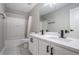 Modern bathroom with a double sink vanity, black hardware, and a shower-tub combination at 1784 Hollingsworth Nw Blvd, Atlanta, GA 30318