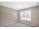 Bedroom with a large window providing natural light and plush carpet at 1784 Hollingsworth Nw Blvd, Atlanta, GA 30318