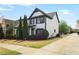 A view of the 2-story home showing landscaped yard with black mulch and concrete driveway at 1784 Hollingsworth Nw Blvd, Atlanta, GA 30318