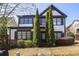 Charming two-story home with black trim, fresh landscaping, and inviting stone walkway at 1784 Hollingsworth Nw Blvd, Atlanta, GA 30318