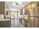 Kitchen featuring stainless steel appliances, subway tile backsplash, and neutral countertops at 1784 Hollingsworth Nw Blvd, Atlanta, GA 30318