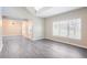 Spacious living room with high ceilings, natural light, and modern gray wood flooring at 1784 Hollingsworth Nw Blvd, Atlanta, GA 30318