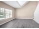 Bright living room with vaulted ceiling, neutral paint, and sleek wood-look floors at 1784 Hollingsworth Nw Blvd, Atlanta, GA 30318
