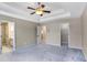 Bright main bedroom with neutral walls, ceiling fan, tray ceiling, walk-in closet, and ensuite bathroom at 1784 Hollingsworth Nw Blvd, Atlanta, GA 30318