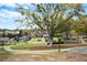 Community playground and park area with mature trees and walking paths at 1784 Hollingsworth Nw Blvd, Atlanta, GA 30318