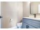 Powder room with grey vanity, black hardware, and a modern mirror at 1784 Hollingsworth Nw Blvd, Atlanta, GA 30318