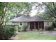 A quaint single-story home featuring a screened-in porch and mature shade trees at 1908 Bouldercrest Se Rd, Atlanta, GA 30316