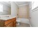 Bathroom featuring tiled shower over tub, single sink vanity with storage, and tiled floors at 2619 Del Ridge Dr, Douglasville, GA 30135