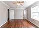 Bright bedroom with hardwood floors, ceiling fan, large window, and easy access to the bathroom at 2619 Del Ridge Dr, Douglasville, GA 30135