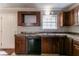 Functional kitchen featuring laminate countertops, black dishwasher and cabinetry at 2619 Del Ridge Dr, Douglasville, GA 30135