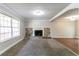 Bright living room featuring a stone fireplace, plush carpet, and large window at 2619 Del Ridge Dr, Douglasville, GA 30135