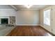 Living room features neutral paint, wood flooring, with stone fireplace and natural light at 2619 Del Ridge Dr, Douglasville, GA 30135