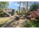 Relaxing backyard with cozy seating around a fire pit, a deck with a hammock, and lush greenery at 323 Fayetteville Rd, Decatur, GA 30030