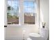 Bathroom includes bright window above the toilet offering a view of the neighborhood at 323 Fayetteville Rd, Decatur, GA 30030
