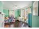 Colorful bedroom with hardwood floors, ample light and eclectic accents at 323 Fayetteville Rd, Decatur, GA 30030
