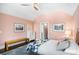 Bedroom with pink walls, tray ceiling, decorative rug, and charming, colorful bedspread at 323 Fayetteville Rd, Decatur, GA 30030