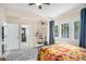 Bedroom with a bed dressed with a bright colored quilt, guitar, shelves, and tray ceiling at 323 Fayetteville Rd, Decatur, GA 30030