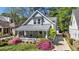 Charming home with a welcoming front porch, beautiful azaleas, and a well-manicured lawn at 323 Fayetteville Rd, Decatur, GA 30030