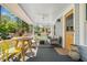 Inviting front porch with stylish furniture, ceiling fan, and a yellow door at 323 Fayetteville Rd, Decatur, GA 30030