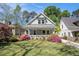 Charming home featuring a cozy front porch, vibrant azaleas, and lush green lawn at 323 Fayetteville Rd, Decatur, GA 30030