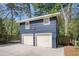 Two car garage with blue painted siding, white garage doors, and upstairs space at 323 Fayetteville Rd, Decatur, GA 30030
