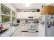 Well-lit kitchen featuring white cabinets, granite countertops, and stainless steel appliances at 323 Fayetteville Rd, Decatur, GA 30030