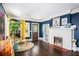 Stylish living room with a cozy fireplace, rich hardwood floors, and elegant decor at 323 Fayetteville Rd, Decatur, GA 30030