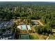 Stunning aerial view of the community pool, clubhouse, and tennis courts surrounded by lush greenery at 3669 High Green Dr, Marietta, GA 30068