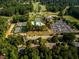 An aerial view shows tennis courts, a swimming pool, and golf course near the neighborhood homes at 3669 High Green Dr, Marietta, GA 30068
