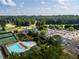 A community pool is seen from above next to tennis courts and the club house at 3669 High Green Dr, Marietta, GA 30068