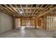 Unfinished basement with walkout access, exposed beams and concrete foundation, offering potential for customization at 3669 High Green Dr, Marietta, GA 30068