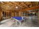 Unfinished basement featuring exposed beams, open layout, and ping pong table, offering customizable living space at 3669 High Green Dr, Marietta, GA 30068