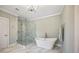 Elegant bathroom featuring marble floors, stand alone soaking tub, and glass enclosed shower at 3669 High Green Dr, Marietta, GA 30068