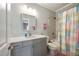 Bright bathroom featuring a vanity with quartz counters and a shower/tub combination with colorful curtain at 3669 High Green Dr, Marietta, GA 30068