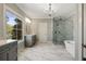 Bright bathroom featuring marble floors, dual vanities, chandelier, soaking tub, and glass enclosed shower at 3669 High Green Dr, Marietta, GA 30068