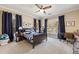 Bedroom with a neutral color palette featuring two windows with views, a ceiling fan, and carpet at 3669 High Green Dr, Marietta, GA 30068