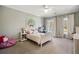 Bedroom with a neutral color palette featuring two windows with views, a ceiling fan, and carpet at 3669 High Green Dr, Marietta, GA 30068