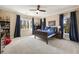 Bedroom with a neutral color palette featuring two windows with views, a ceiling fan, and carpet at 3669 High Green Dr, Marietta, GA 30068