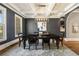 A dining room with dark accent walls, a coffered ceiling, a decorative light fixture, and a large dining table at 3669 High Green Dr, Marietta, GA 30068