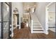 Grand foyer with soaring ceilings, hardwood floors, staircase, and views into other rooms at 3669 High Green Dr, Marietta, GA 30068