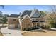Gorgeous home with a large driveway, attached garage and a basketball court in a wooded lot at 3669 High Green Dr, Marietta, GA 30068