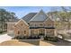 Beautiful brick and stone home featuring a spacious front yard and a welcoming front porch at 3669 High Green Dr, Marietta, GA 30068