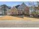 A beautiful two story house showcasing manicured lawn, brickwork, and manicured landscaping at 3669 High Green Dr, Marietta, GA 30068