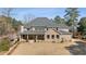 Elegant brick home with a large backyard, covered porch, well-manicured lawn, and mature trees at 3669 High Green Dr, Marietta, GA 30068