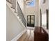 Bright foyer featuring tall ceilings, hardwood floors, staircase with iron railing, and double entry doors at 3669 High Green Dr, Marietta, GA 30068