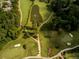 An aerial view shows a well-manicured golf course with water features and tree lined fairways at 3669 High Green Dr, Marietta, GA 30068