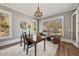 Inviting home office with large windows, hardwood floors, modern lighting and comfortable seating at 3669 High Green Dr, Marietta, GA 30068