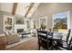 Open-concept living room featuring high ceilings with wooden beams, a fireplace, and large windows at 3669 High Green Dr, Marietta, GA 30068