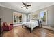 Comfortable bedroom featuring hardwood floors, a ceiling fan, and views of the surrounding landscape at 3669 High Green Dr, Marietta, GA 30068